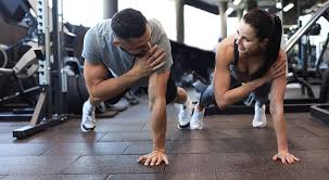 Image of man and woman doing Cardio Northamptonshire to tone their arms. 